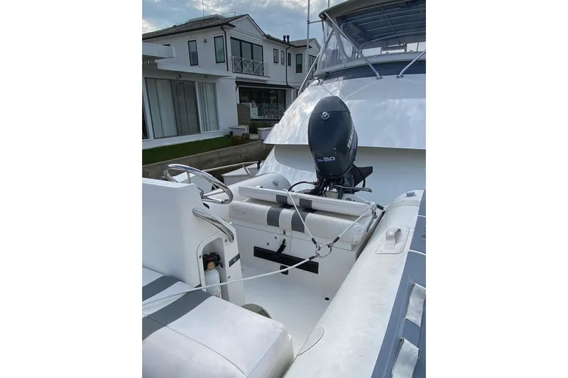  Yacht Photos Pics 1995 Hatteras 50 Convertible Sportfish boat with Yamaha outboard motor, docked near modern house.