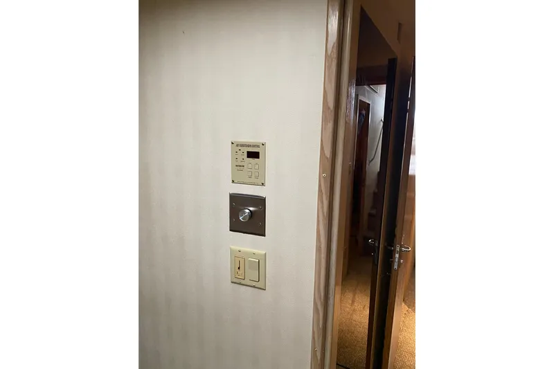  Yacht Photos Pics Interior view of 1995 Hatteras 50 Convertible Sportfish with control panels on wall.