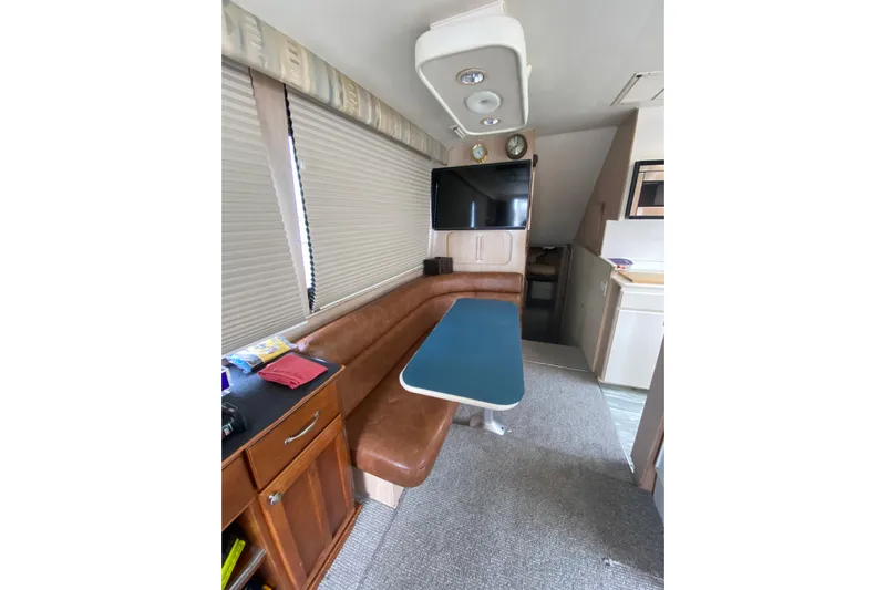 Yacht Photos Pics Interior of 1995 Hatteras 50 Convertible Sportfish with dining area and TV.