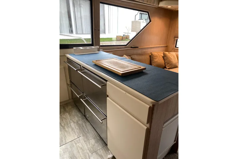  Yacht Photos Pics Interior of 1995 Hatteras 50 Convertible Sportfish with modern kitchen and seating area.