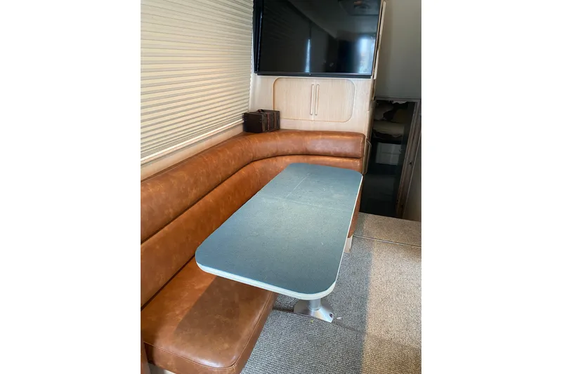  Yacht Photos Pics Interior of 1995 Hatteras 50 Convertible Sportfish with leather seating and dining table.