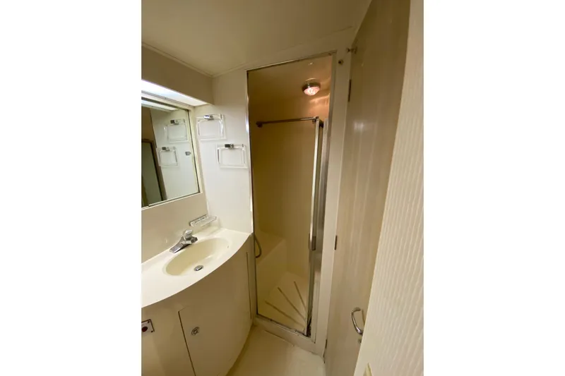  Yacht Photos Pics Bathroom interior of 1995 Hatteras 50 Convertible Sportfish yacht, featuring sink and shower.