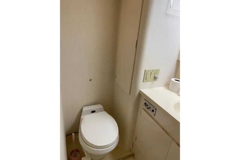  Yacht Photos Pics Bathroom interior of 1995 Hatteras 50 Convertible Sportfish yacht, featuring toilet and sink.