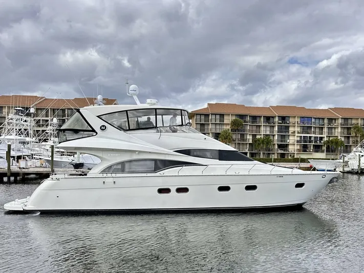  Yacht Photos Pics 2006 Marquis Flybridge Motor Yacht docked in marina, cloudy sky background.