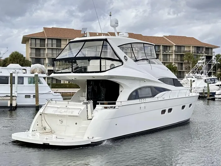  Yacht Photos Pics 2006 Marquis Flybridge Motor Yacht docked in marina, with modern design and spacious deck.