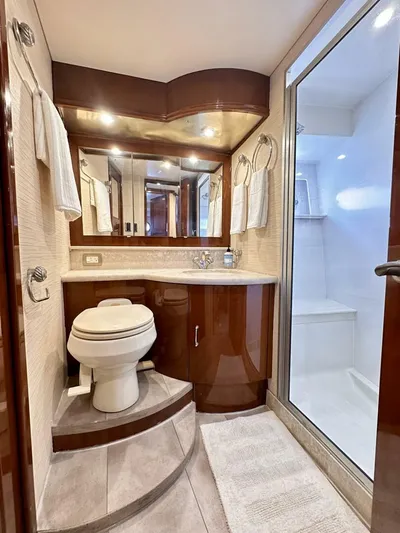  Yacht Photos Pics Luxurious bathroom in 2006 Marquis Flybridge Motor Yacht with elegant wood cabinetry.