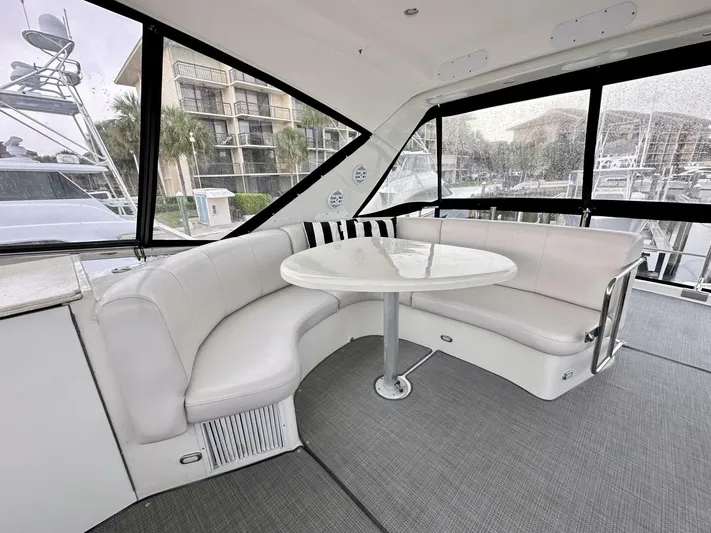  Yacht Photos Pics 2006 Marquis Flybridge Motor Yacht interior with white seating and round table.