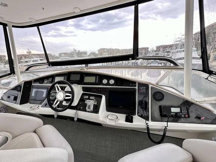  Yacht Photos Pics Helm of 2006 Marquis Flybridge Motor Yacht with modern navigation equipment.