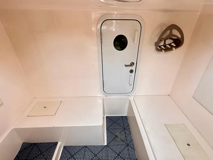  Yacht Photos Pics Interior of a 2006 Marquis Flybridge Motor Yacht with a white door and seating area.