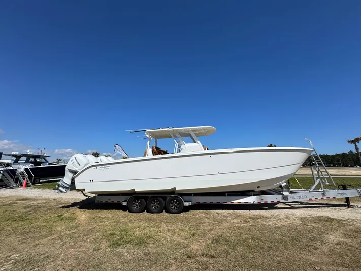  Yacht Photos Pics 2023 Invincible 37 Catamaran on trailer under clear blue sky.