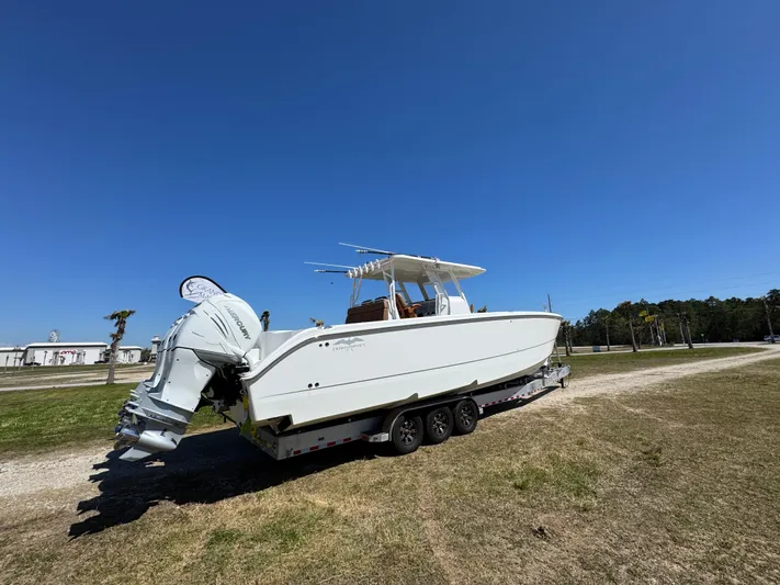  Yacht Photos Pics 2023 Invincible 37 Catamaran on trailer under clear blue sky.
