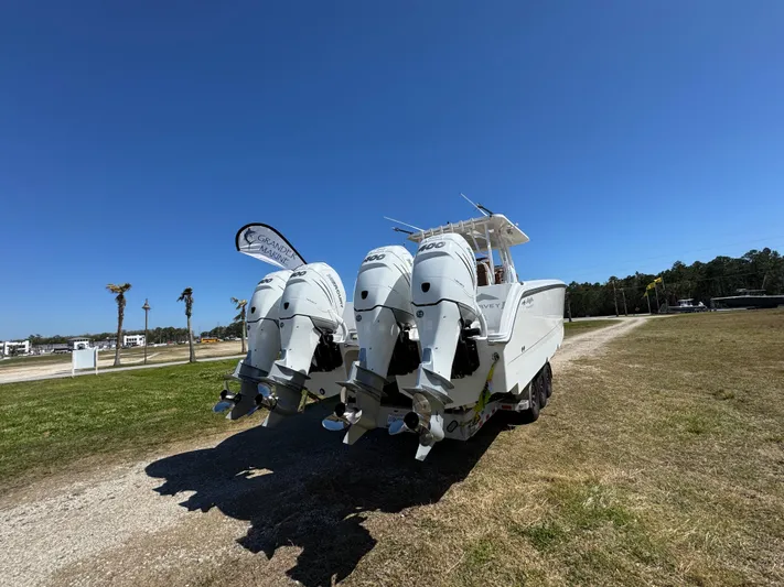  Yacht Photos Pics 2023 Invincible 37 Catamaran with four powerful outboard engines on a sunny day.