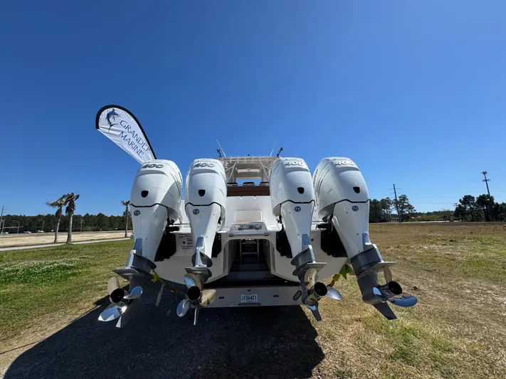  Yacht Photos Pics 2023 Invincible 37 Catamaran with four powerful outboard engines, displayed outdoors.