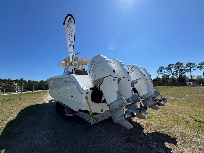  Yacht Photos Pics 2023 Invincible 37 Catamaran with triple outboard engines on display outdoors.