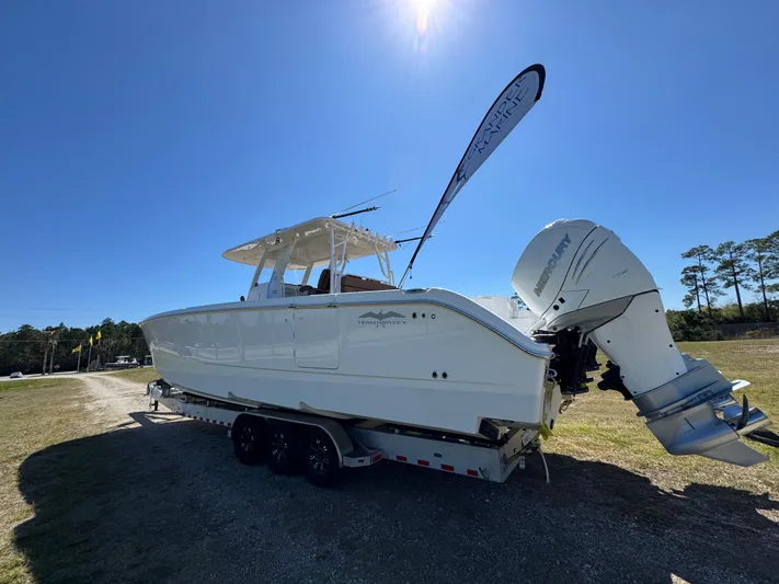  Yacht Photos Pics 2023 Invincible 37 Catamaran on trailer under clear blue sky.