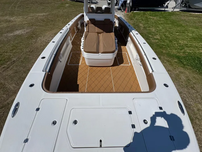  Yacht Photos Pics 2023 Invincible 37 Catamaran with spacious deck and seating, showcased on grass.