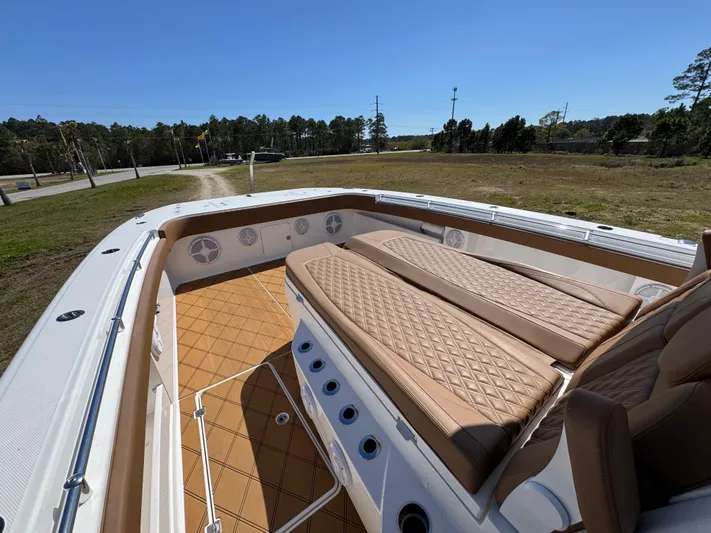  Yacht Photos Pics 2023 Invincible 37 Catamaran with tan seating and spacious deck in a scenic outdoor setting.