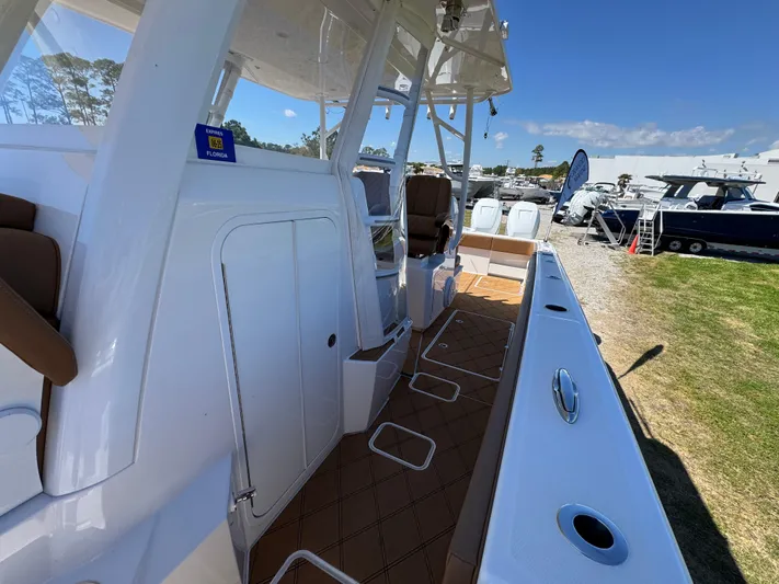 Yacht Photos Pics 2023 Invincible 37 Catamaran, sleek deck view, docked outdoors under clear sky.