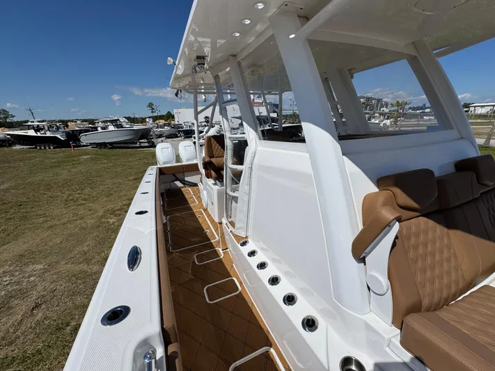  Yacht Photos Pics 2023 Invincible 37 Catamaran with sleek design and luxurious seating on display outdoors.