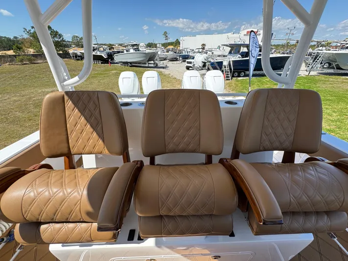  Yacht Photos Pics Luxurious seating on 2023 Invincible 37 Catamaran, featuring tan leather upholstery and diamond stitching.