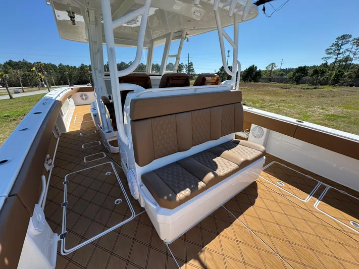  Yacht Photos Pics 2023 Invincible 37 Catamaran interior with brown seating and deck, showcasing luxury and comfort.