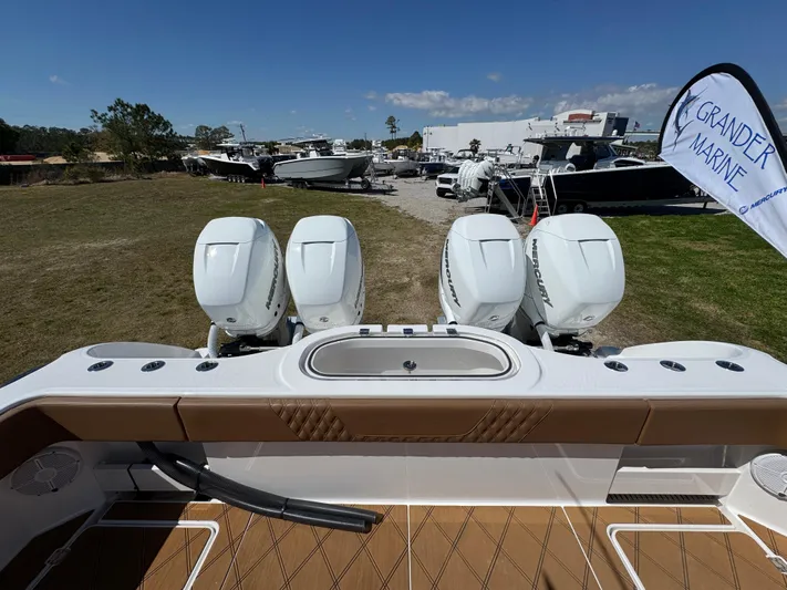  Yacht Photos Pics 2023 Invincible 37 Catamaran with four powerful outboard engines, displayed at a marine dealership.