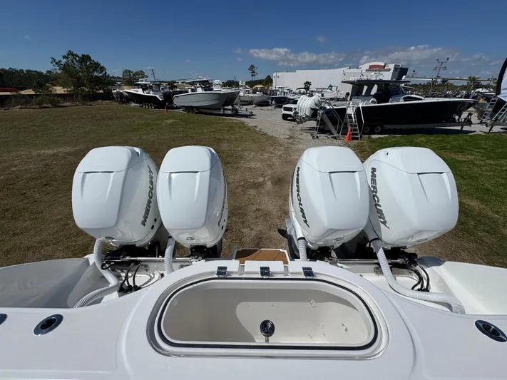  Yacht Photos Pics 2023 Invincible 37 Catamaran with four powerful outboard engines, docked in a marina.