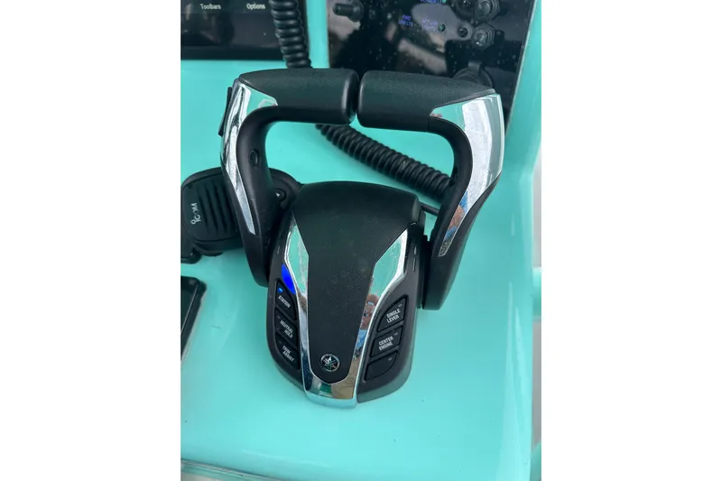  Yacht Photos Pics 2026 Stanley White Fishmaster boat throttle control on turquoise dashboard.