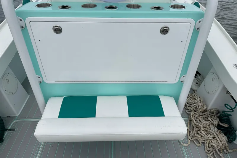  Yacht Photos Pics Stanley White Fishmaster 2026 boat seat with teal and white design, featuring storage and cup holders.
