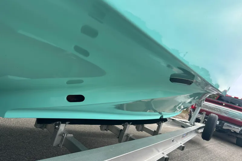  Yacht Photos Pics 2026 Stanley White Fishmaster boat on trailer, showcasing sleek turquoise hull design.