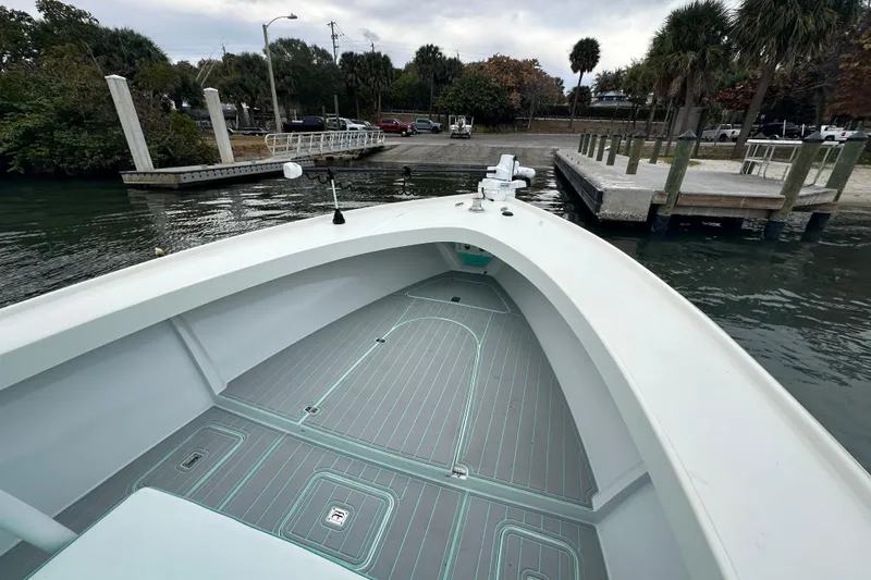  Yacht Photos Pics 2026 Stanley White Fishmaster boat docked at a marina with palm trees.