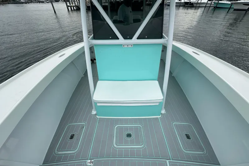  Yacht Photos Pics 2026 Stanley White Fishmaster boat interior with teal accents and gray flooring.
