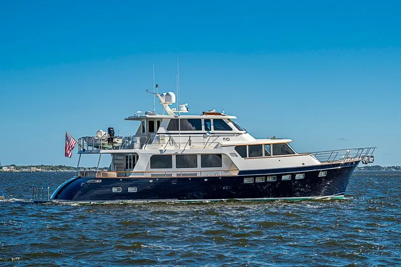 Ben's Barge Yacht Photos Pics 2014 Marlow Explorer 66E yacht cruising on open water under clear blue skies.