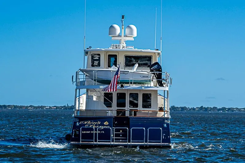 Ben's Barge Yacht Photos Pics 2014 Marlow Explorer 66E yacht cruising on open water under clear blue skies.