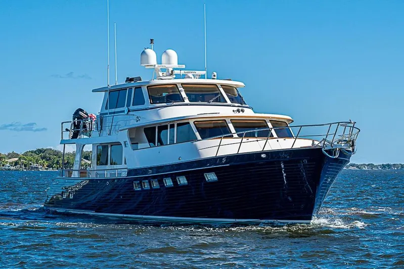Ben's Barge Yacht Photos Pics 2014 Marlow Explorer 66E yacht cruising on open water under clear blue skies.