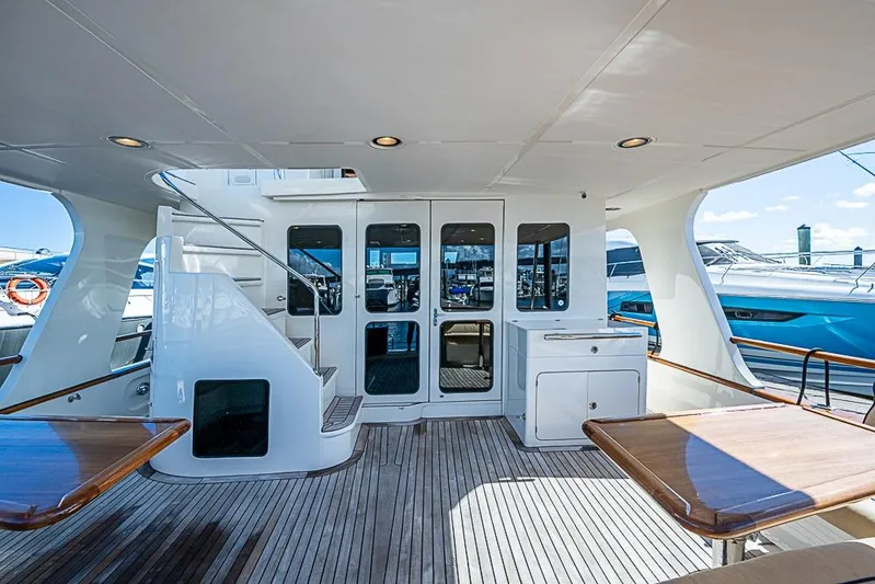 Ben's Barge Yacht Photos Pics Luxurious 2014 Marlow Explorer 66E yacht deck with elegant wood finish and modern amenities.