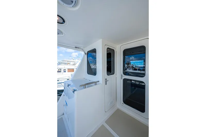 Ben's Barge Yacht Photos Pics 2014 Marlow Explorer 66E yacht deck with sleek white design and modern windows.