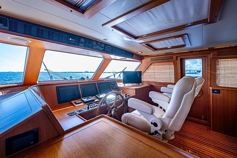 Ben's Barge Yacht Photos Pics Luxurious interior of 2014 Marlow Explorer 66E yacht with modern navigation equipment.
