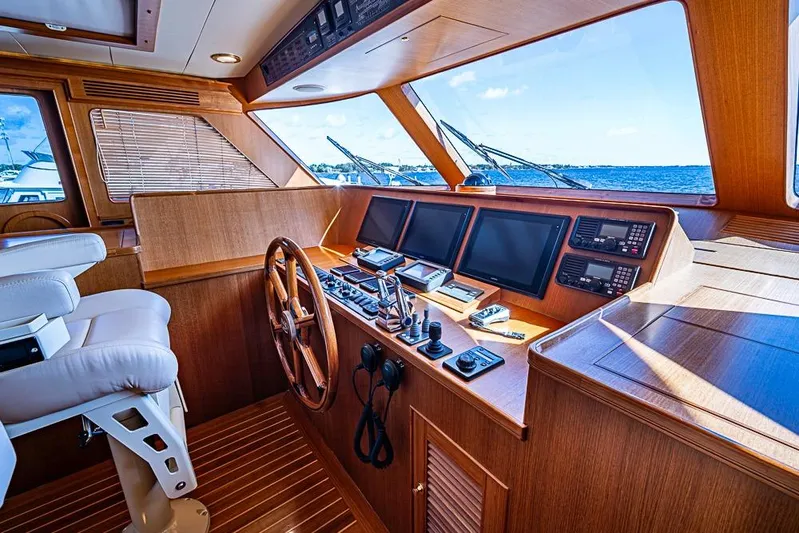 Ben's Barge Yacht Photos Pics Luxurious 2014 Marlow Explorer 66E yacht helm with wooden finish and advanced navigation systems.