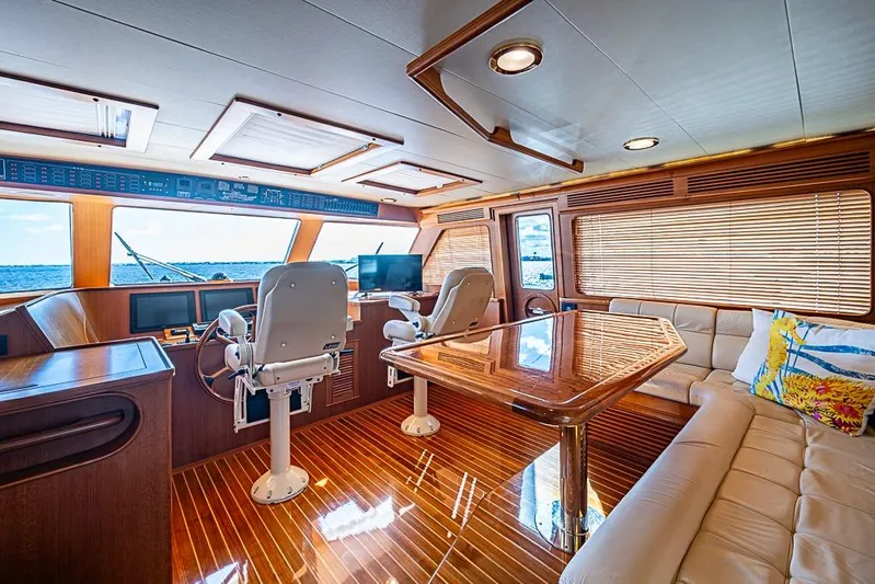 Ben's Barge Yacht Photos Pics Luxurious interior of 2014 Marlow Explorer 66E yacht with wood finishes and plush seating.