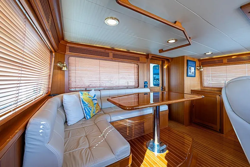 Ben's Barge Yacht Photos Pics Luxurious interior of 2014 Marlow Explorer 66E yacht with elegant wood finishes and plush seating.