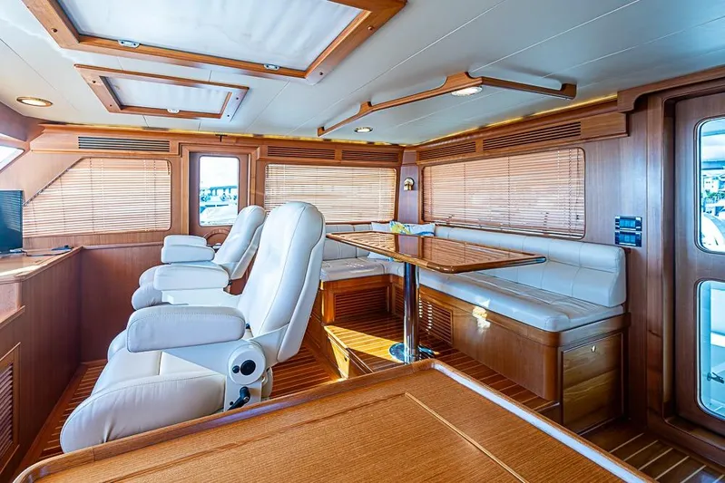 Ben's Barge Yacht Photos Pics Luxurious interior of 2014 Marlow Explorer 66E yacht with plush seating and wooden accents.