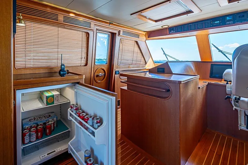 Ben's Barge Yacht Photos Pics Interior of 2014 Marlow Explorer 66E yacht with open fridge and wooden finishes.