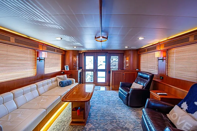 Ben's Barge Yacht Photos Pics Luxurious interior of 2014 Marlow Explorer 66E yacht with elegant seating and wooden accents.