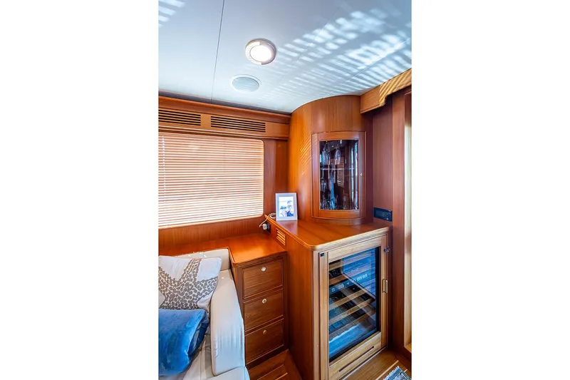 Ben's Barge Yacht Photos Pics Luxurious interior of 2014 Marlow Explorer 66E yacht with wooden cabinetry and wine cooler.