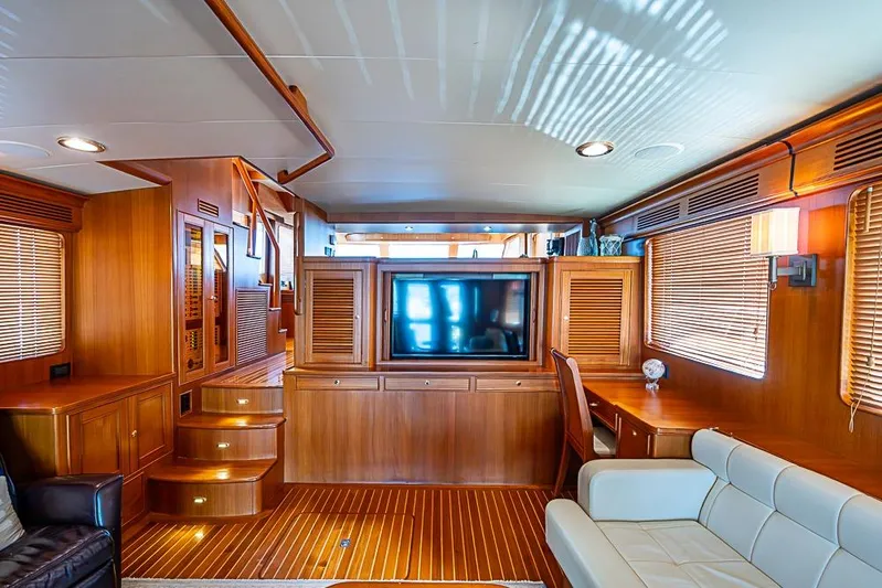 Ben's Barge Yacht Photos Pics Luxurious interior of 2014 Marlow Explorer 66E yacht with wood paneling and modern furnishings.