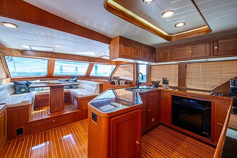 Ben's Barge Yacht Photos Pics Luxurious interior of 2014 Marlow Explorer 66E yacht with wood finishes and modern amenities.