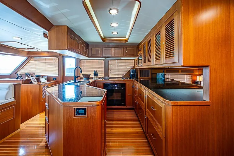 Ben's Barge Yacht Photos Pics Luxurious wooden kitchen interior of 2014 Marlow Explorer 66E yacht.