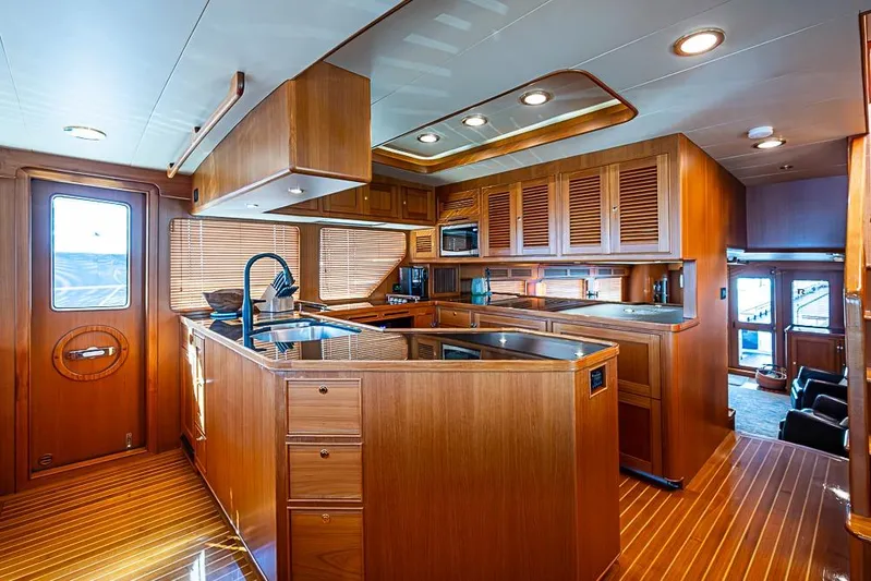 Ben's Barge Yacht Photos Pics Luxurious wooden interior of 2014 Marlow Explorer 66E yacht kitchen.