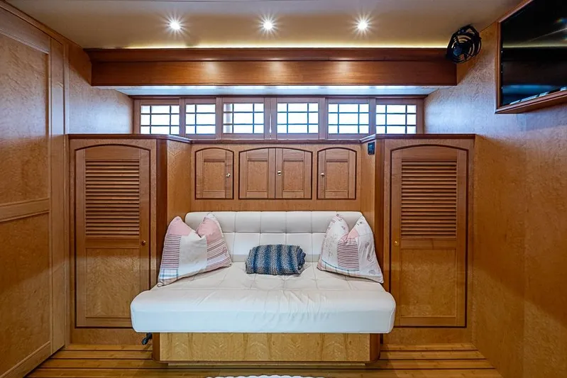 Ben's Barge Yacht Photos Pics Luxurious interior of 2014 Marlow Explorer 66E yacht with cozy seating and wooden cabinetry.